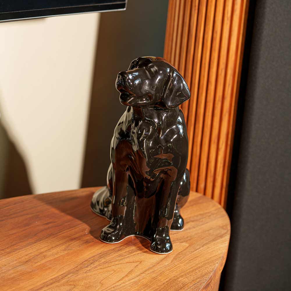 Golden Retriever Pet Urn for Ashes in Glossy Black on Table Facing Left