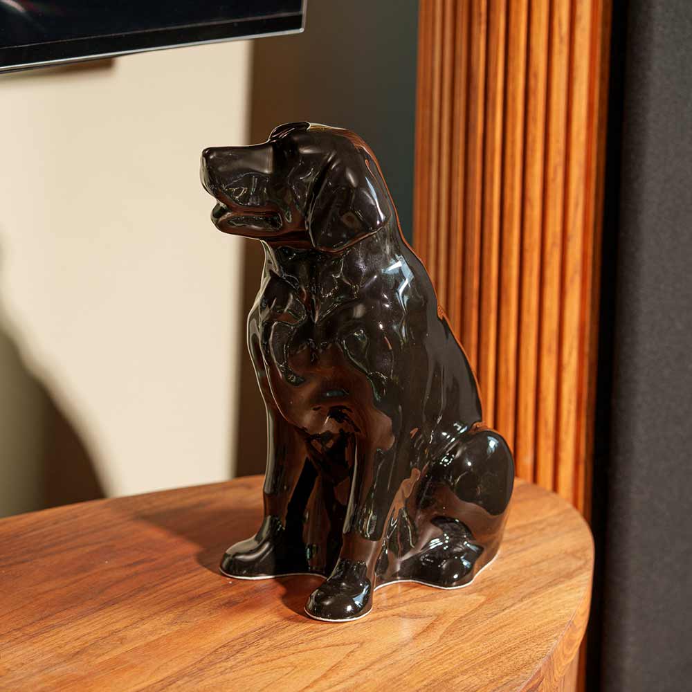 Golden Retriever Pet Urn for Ashes in Glossy Black on Table Left