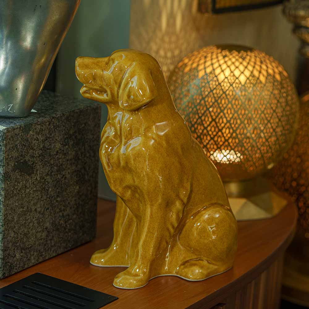 Golden Retriever Pet Urn for Ashes in Gold on Shelf Facing Left