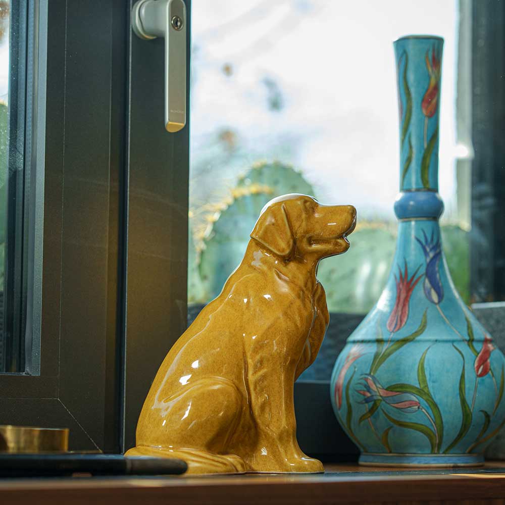 Golden Retriever Pet Urn for Ashes in Gold on Shelf Looking Up