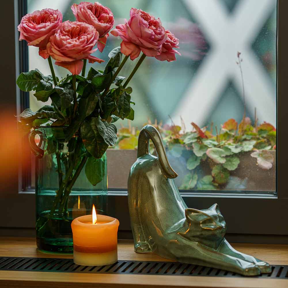 Stretching Cat Urn For Ashes Oily Green On Window With Flowers